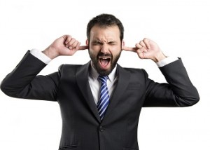 business man covering her ears over white background